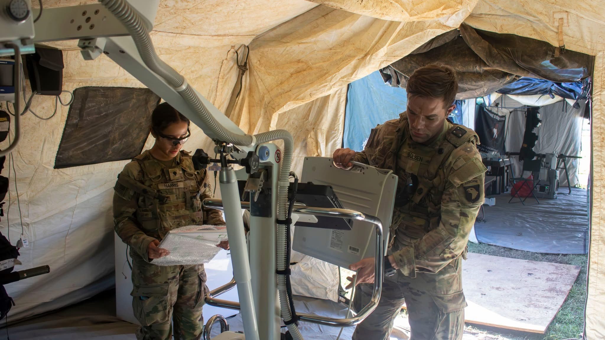 Setting up a portable field X-ray unit in an Army medical tent